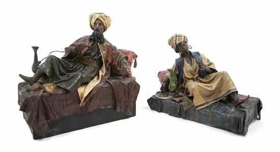 Appraisal: A Pair of Papier Mache Orientalist Figures each in reclining