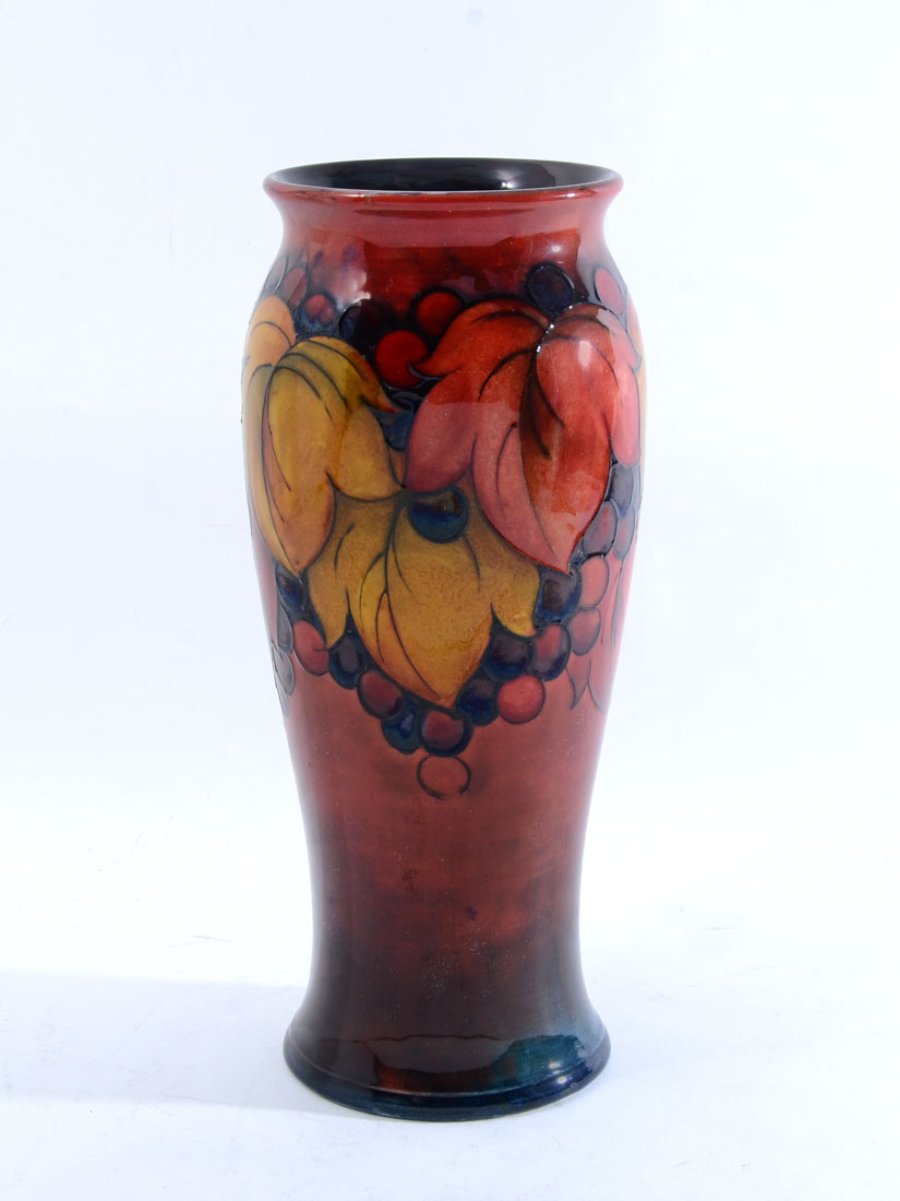 Appraisal: MOORCROFT FLAMBE GRAPE AND VINE VASE Baluster form vase flambe