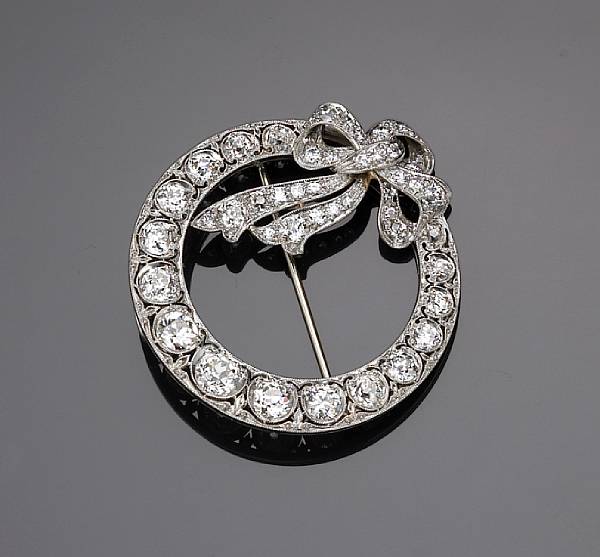 Appraisal: An Edwardian diamond circle and bow brooch set throughout with