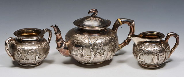 Appraisal: A CHINESE THREE PIECE SILVER TEA SET each showing scenes