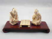 Appraisal: A pair of Chinese ivory figures each signed seated at