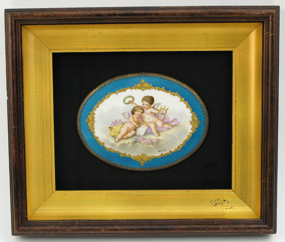 Appraisal: A FRENCH PORCELAIN OVAL PLAQUE hand painted cartouche with cupids