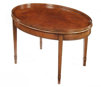 Appraisal: An oval mahogany coffee table the galleried top above a