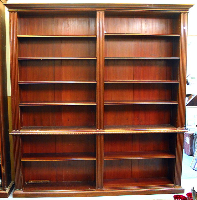 Appraisal: A LARGE GEORGIAN STYLE DARK STAINED LIBRARY BOOKCASE with fluted