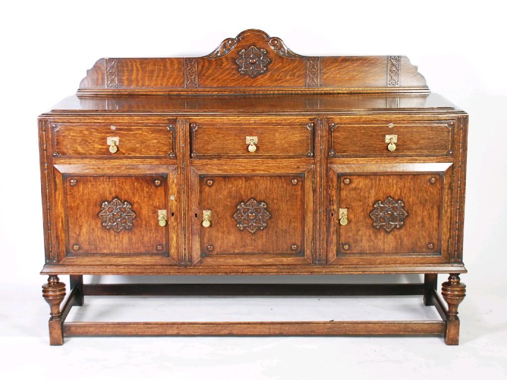 Appraisal: 's JACOBEAN STYLE OAK SIDEBOARD the moulded oblong top with