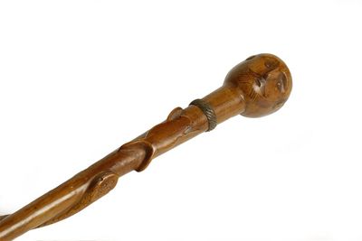 Appraisal: A carved wooden staff the handle modelled as the head