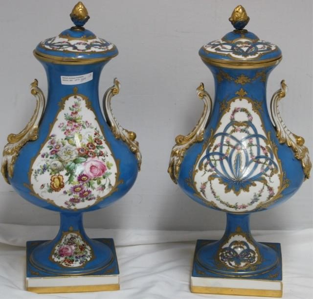 Appraisal: PAIR OF TH CENTURY SEVRES COVERED URNS HANDPAINTED FLORAL DESIGN