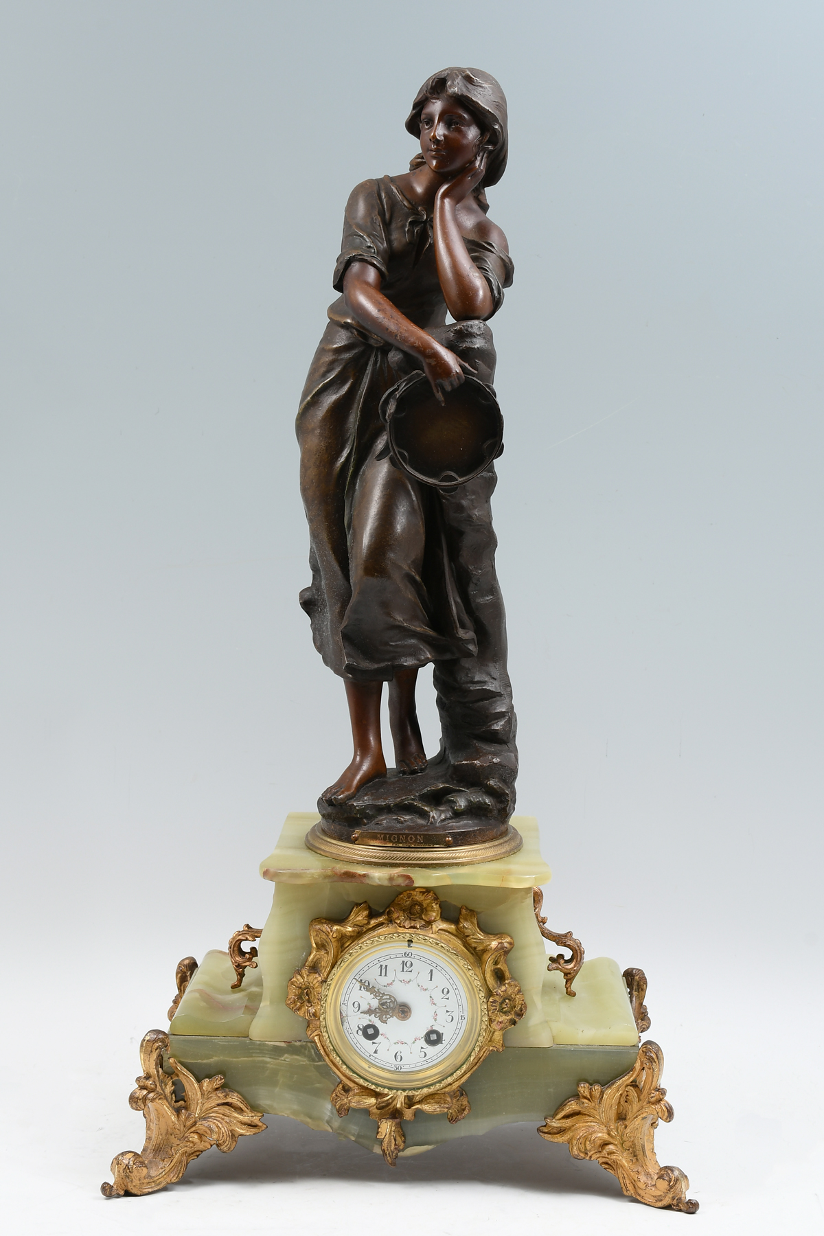 Appraisal: FRENCH FIGURAL ONYX MANTLE CLOCK Surmounting patinated metal sculpture of