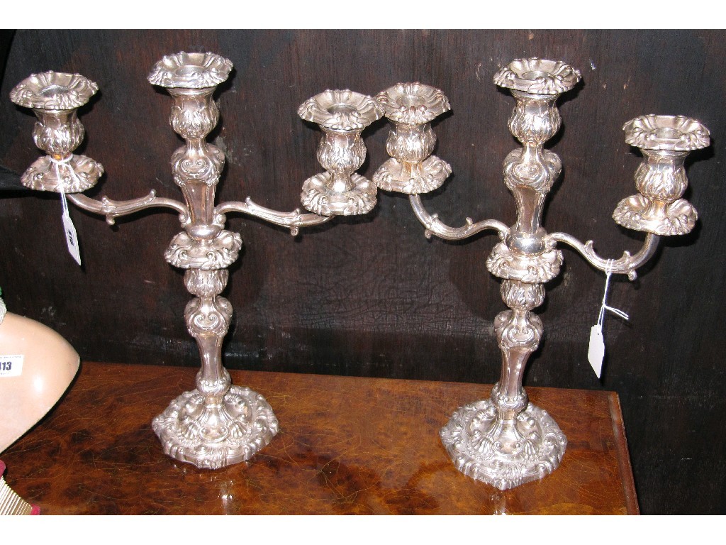 Appraisal: Pair of silver based three-branch candelabra the branches silver plated