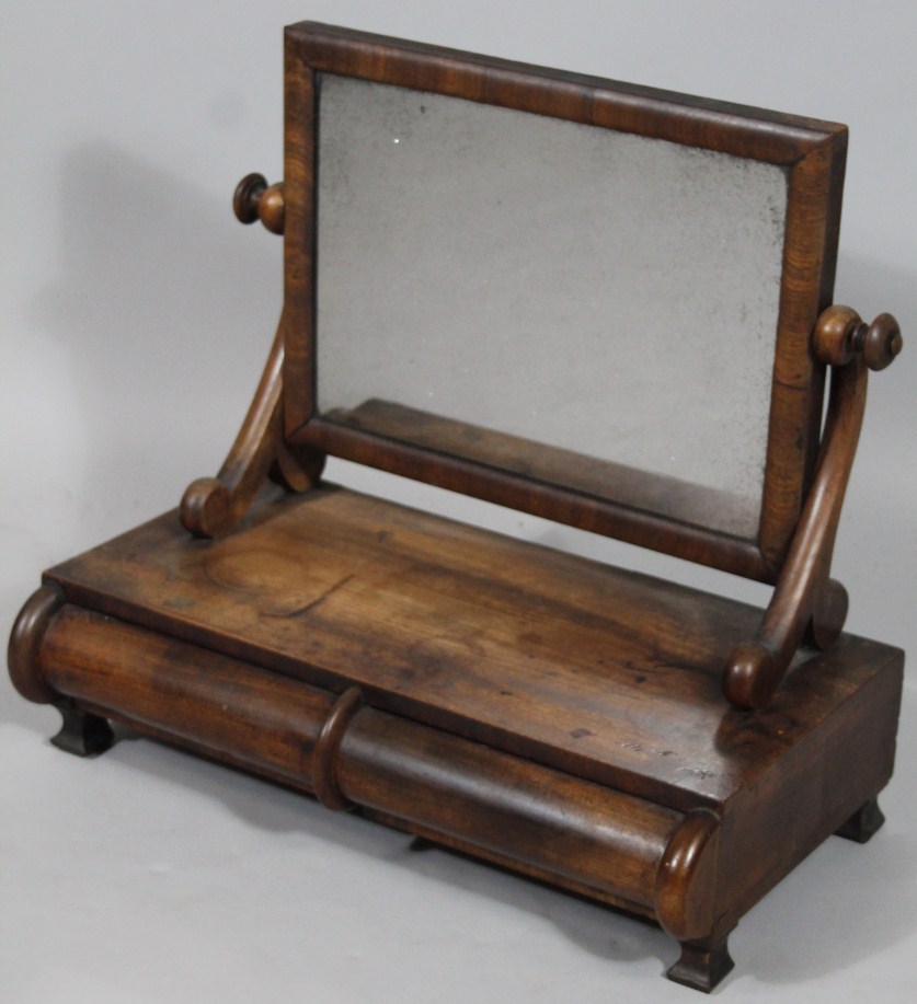 Appraisal: A thC mahogany table mirror with rectangular glass on scroll