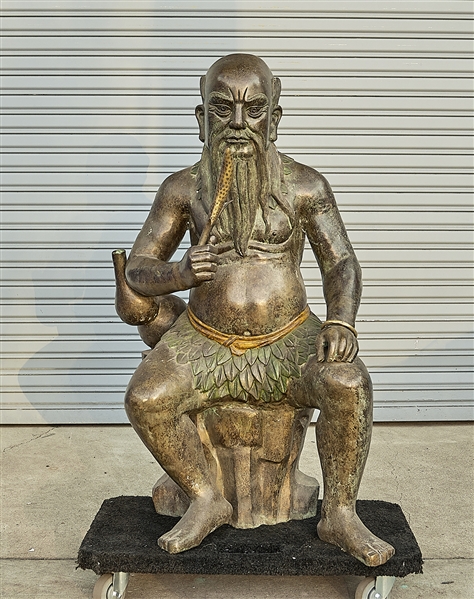 Appraisal: Chinese bronze seated figure holding symbol of the harvest x