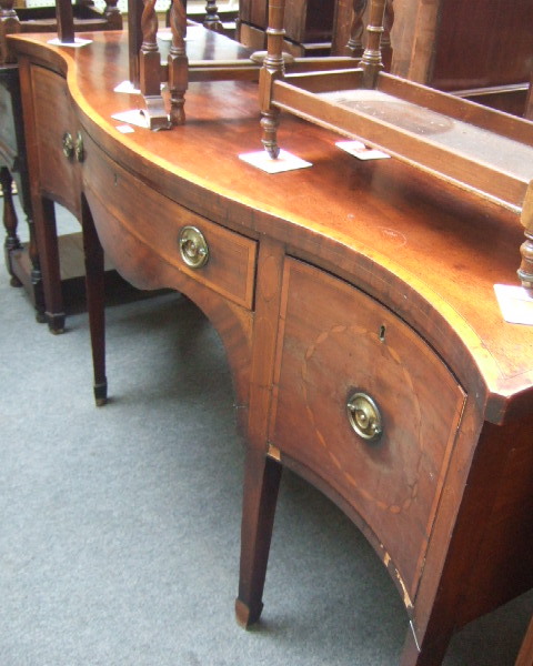 Appraisal: An th century style sideboard the crossbanded serpentine top over