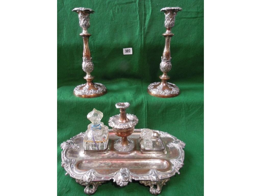 Appraisal: A pair of Old Sheffield plated candlesticks with floral decoration