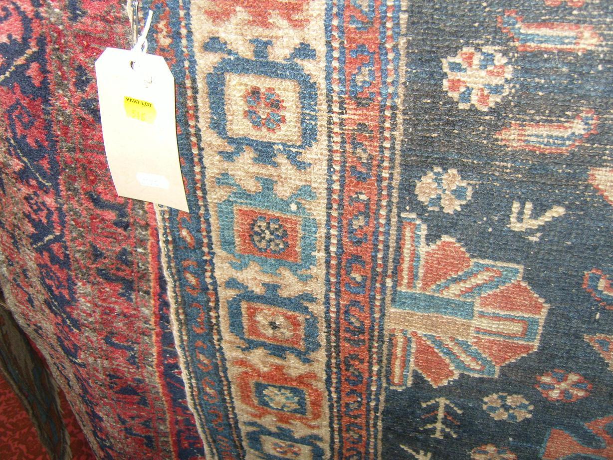 Appraisal: A blue ground eastern wool rug with stylised floral decoration