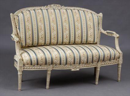 Appraisal: LOUIS XVI-STYLE CARVED AND IVORY-PAINTED CANAPE The padded breakarch back