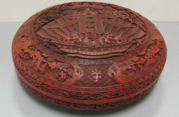 Appraisal: CHINESE CINNABAR STORAGE BOX Lidded circular decorated with Buddha in