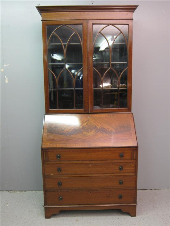 Appraisal: Early th century mahogany and crossbanded bureau bookcase with astragal