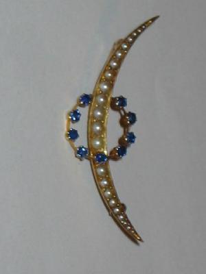 Appraisal: A VICTORIAN SAPPHIRE AND PEARL BROOCH set as a crescent