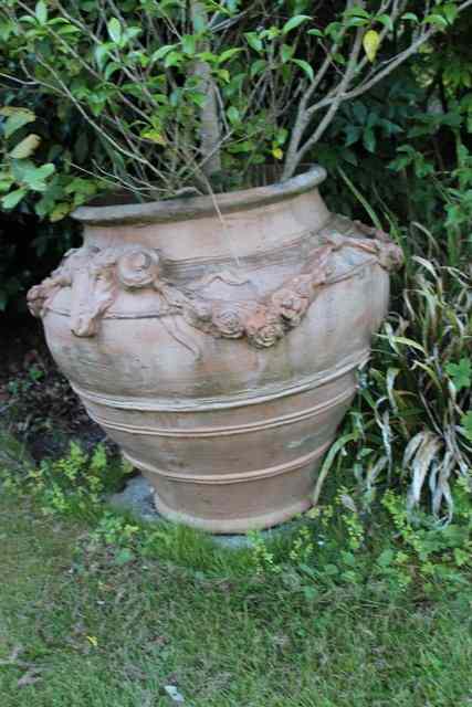 Appraisal: A PAIR OF LARGE COMPOSITE OVOID PLANTERS with ribbed decoration