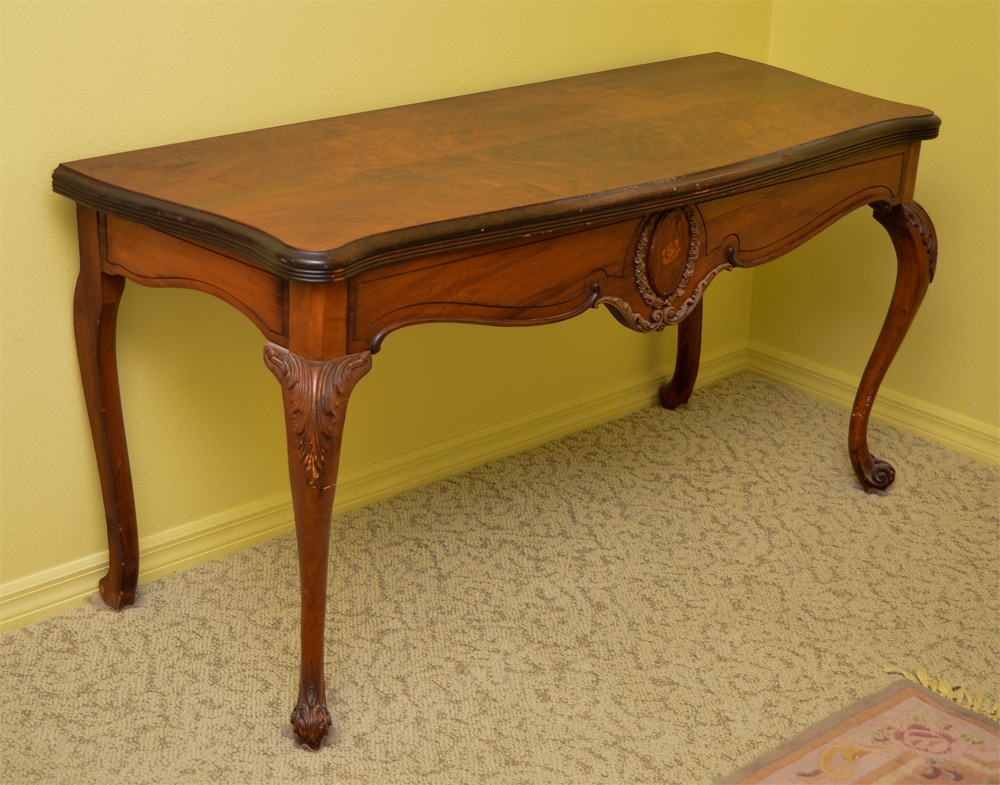 Appraisal: CARVED MAHOGANY FOYER DINING TABLE Shaped mahogany top slides and