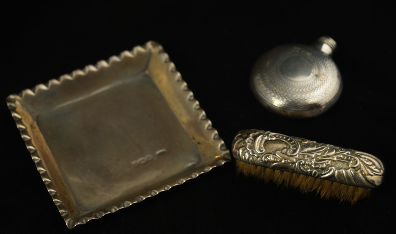 Appraisal: A circular silver scent bottle with engine turned decoration lid