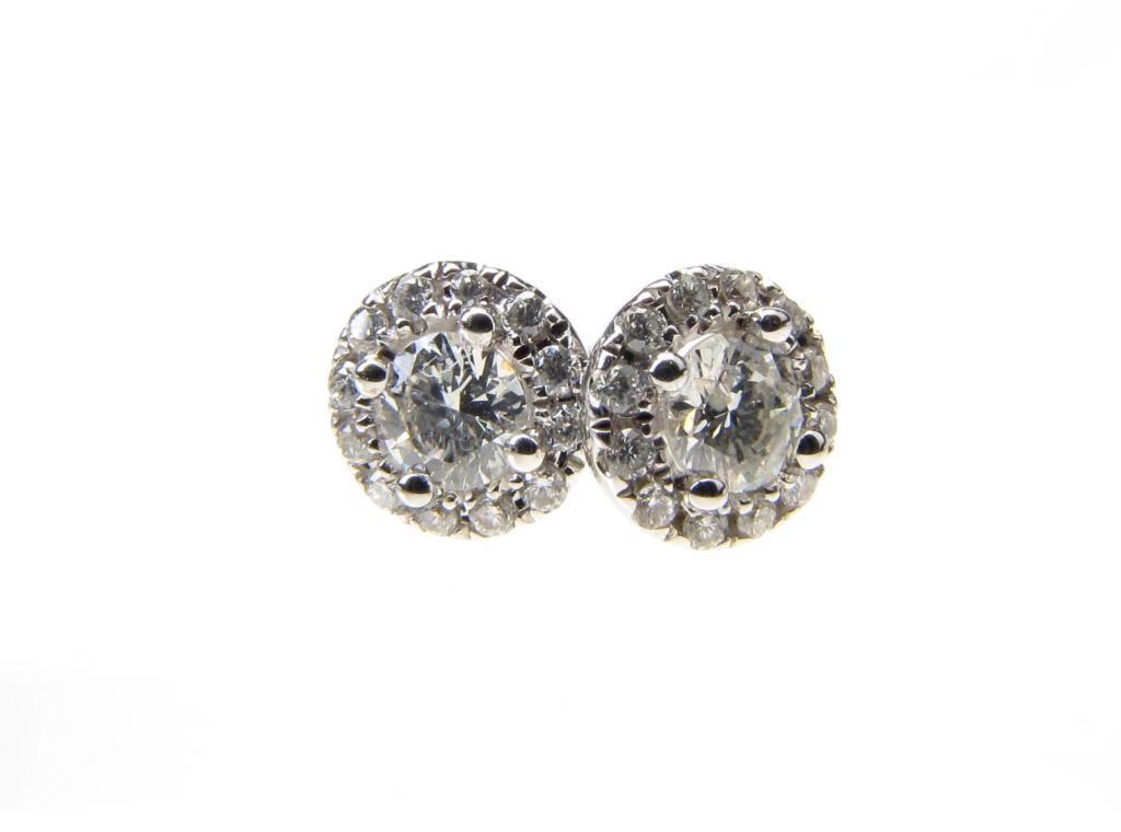 Appraisal: A pair of K white gold earrings with diamond stud