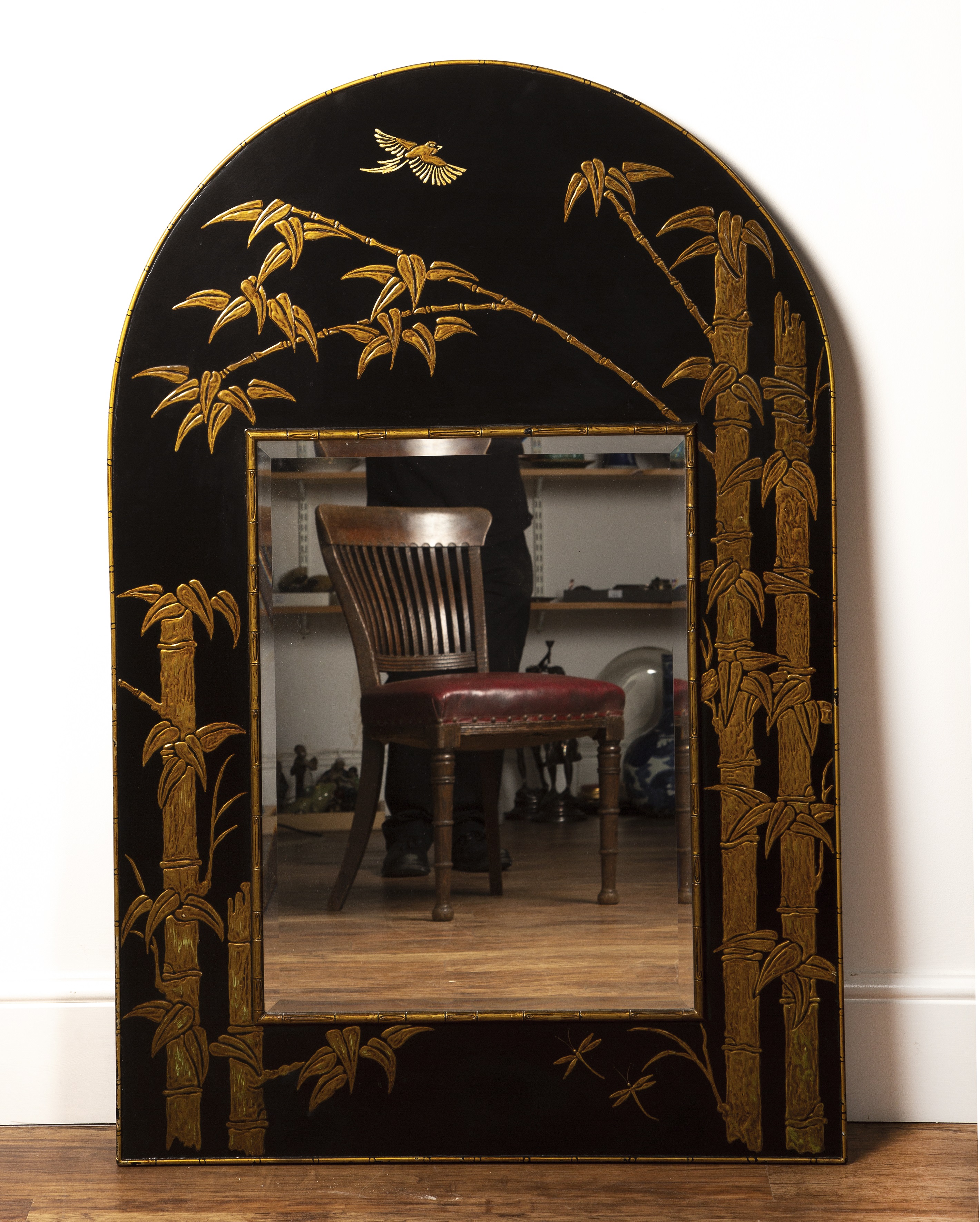 Appraisal: Black ground arched mirror th Century in the Chinese manner