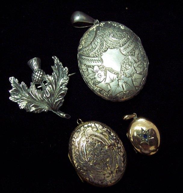 Appraisal: An engraved silver locket Birmingham hallmarks a silver thistle brooch