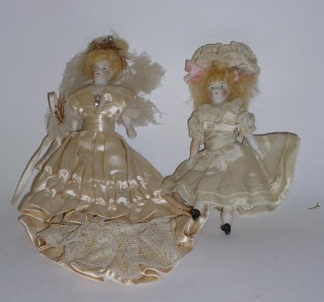 Appraisal: Two similar all bisque shoulder head dolls house dolls painted