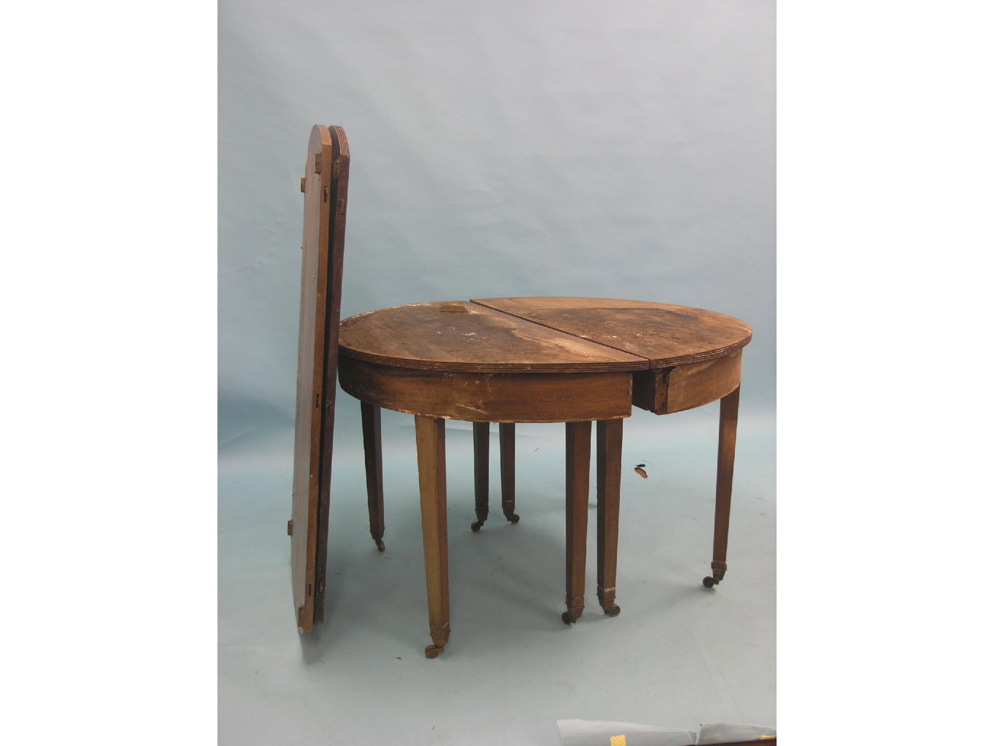 Appraisal: A George III mahogany D-end dining table with two leaves