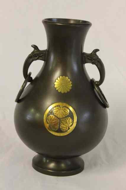 Appraisal: A JAPANESE BRONZE TWO HANDLED VASE with two gilt mons