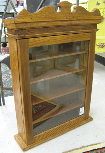 Appraisal: AN OAK WALL CABINET American c having a scroll-cut pediment