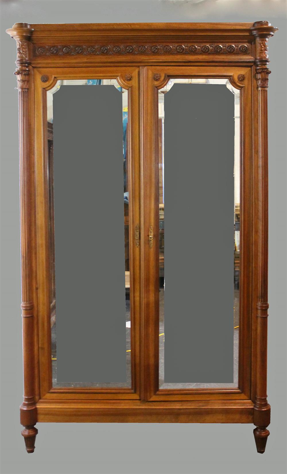 Appraisal: RENAISSANCE REVIVAL CARVED WALNUT MIRRORED ARMOIRE having a carved rosette