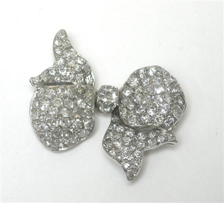 Appraisal: A diamond set bow-form brooch of stylised design pave set