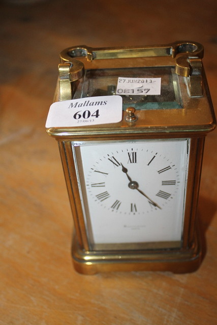 Appraisal: A BRASS CARRIAGE CLOCK with French movement white enamel dial