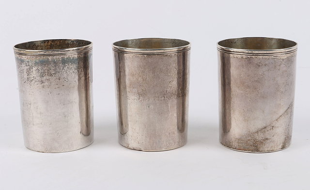 Appraisal: A SET OF THREE CONTINENTAL HAMMERED SILVER BEAKERS reeded lips