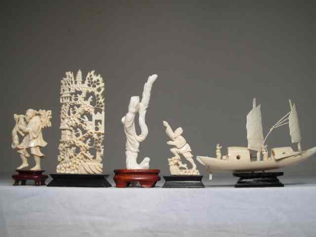 Appraisal: Group lot of ivory carved figurines and displays Includes ornately