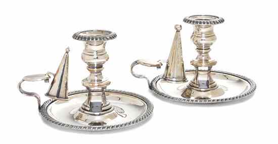 Appraisal: A Pair of Sheffield Plate Chambersticks each having a baluster