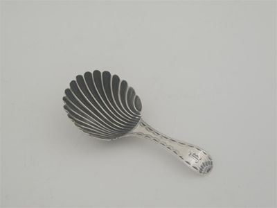 Appraisal: A George III caddy spoon with a shell bowl bright-cut