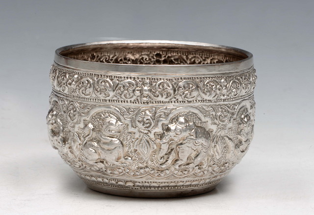 Appraisal: A BURMESE SILVER OPEN BOWL with embossed animals and relief