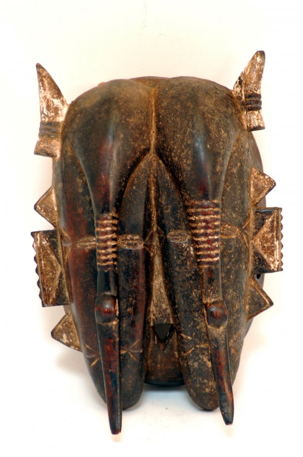 Appraisal: Senufo double mask having two simple stylized faces with overhanging