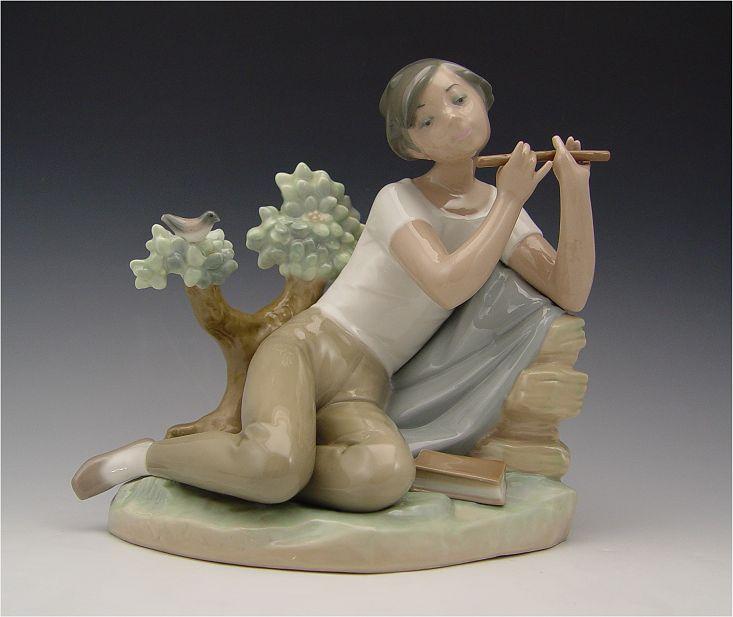 Appraisal: RETIRED LLADRO STUDENT FLUTE PLAYER Retired in Boy playing the