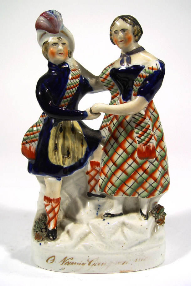 Appraisal: Victorian hand painted Staffordshire figure group with gilded script to