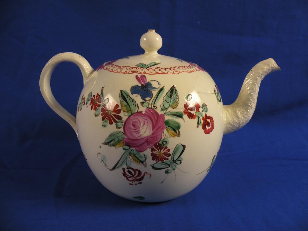 Appraisal: An thC creamware teapot of bullet shape polychrome painted with