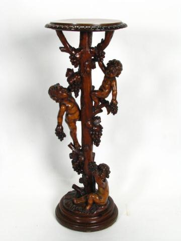 Appraisal: Ornate figural carved fern stand depicting putti holding grapes and