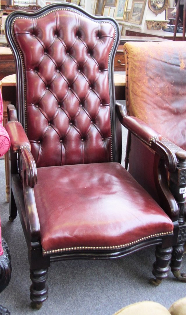 Appraisal: A Victorian mahogany and rouge leather upholstered open arm easy