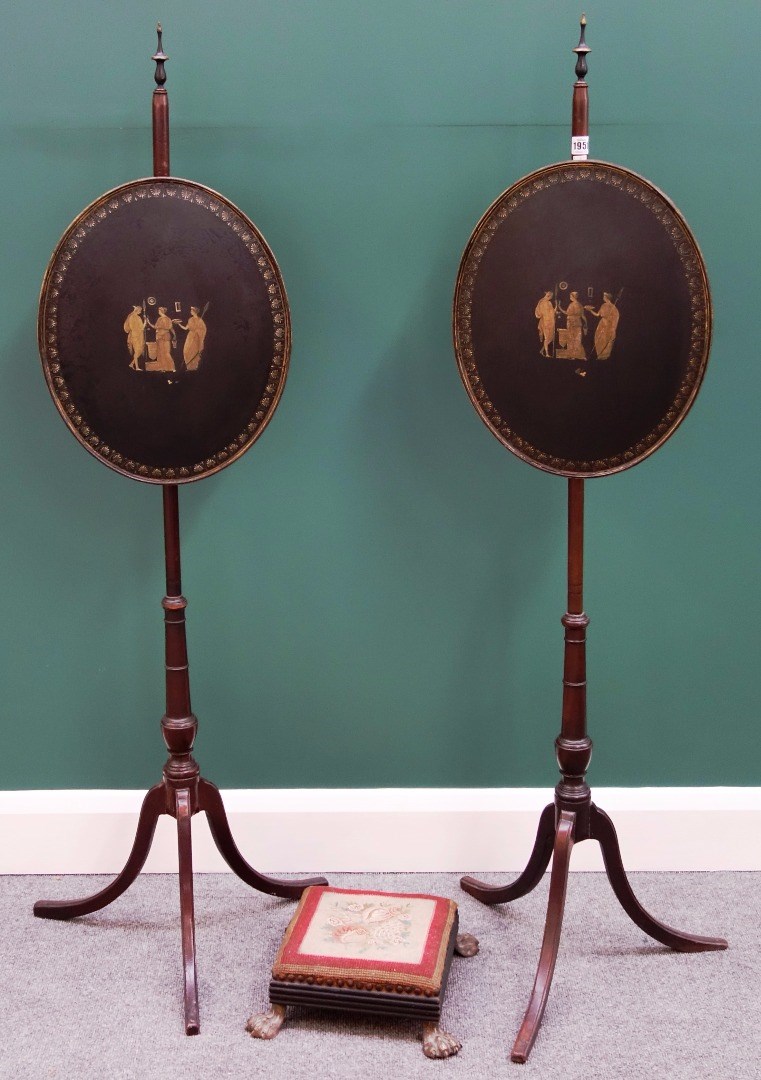 Appraisal: A pair of George III pole screens each with oval