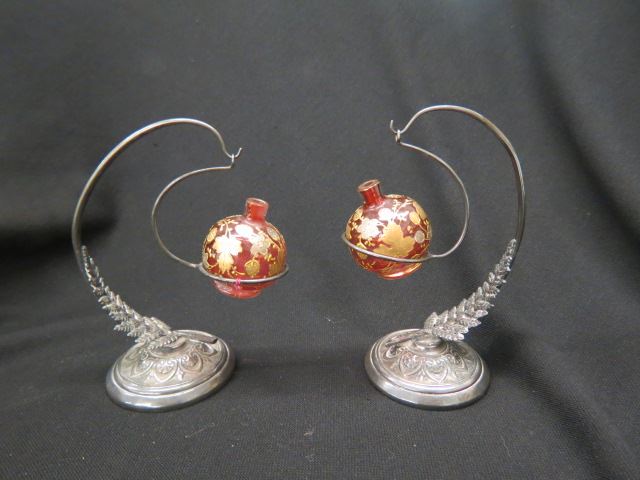 Appraisal: Pair of Victorian Cranberry Art Glass Perfumesin original silverplate holders