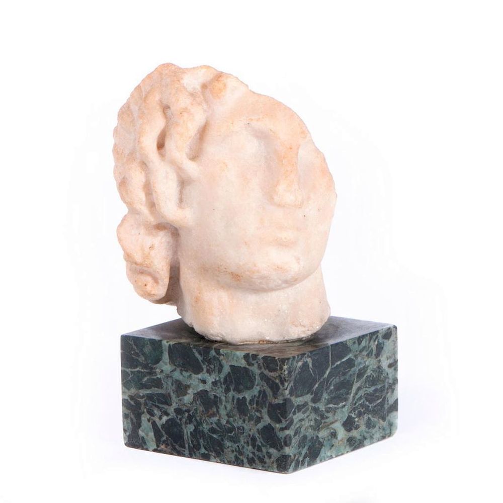 Appraisal: A Greek or Roman marble head An ancient Greek or