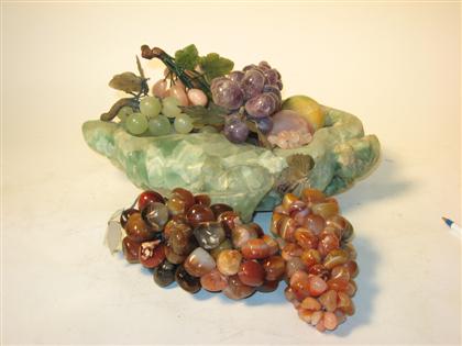 Appraisal: A Green quartz bowl with fruit The freeform bowl stocked